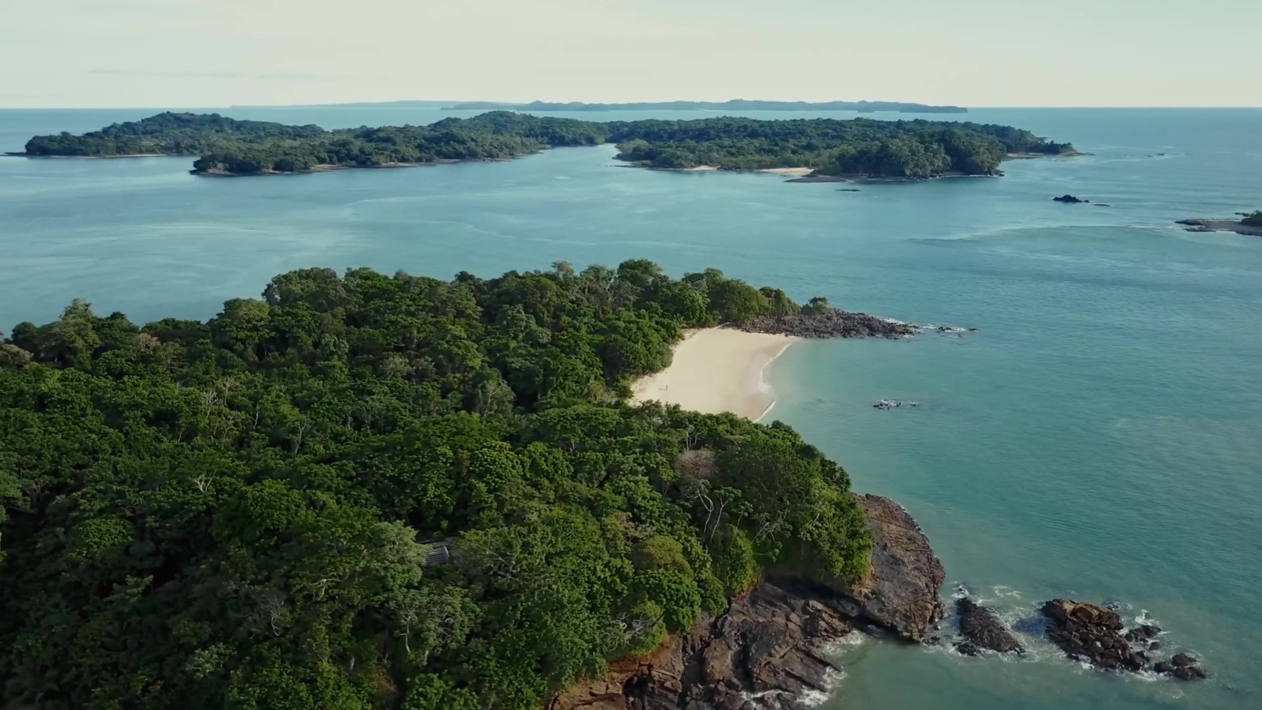 Aerial view of jungle-covered islands and white sand beaches
