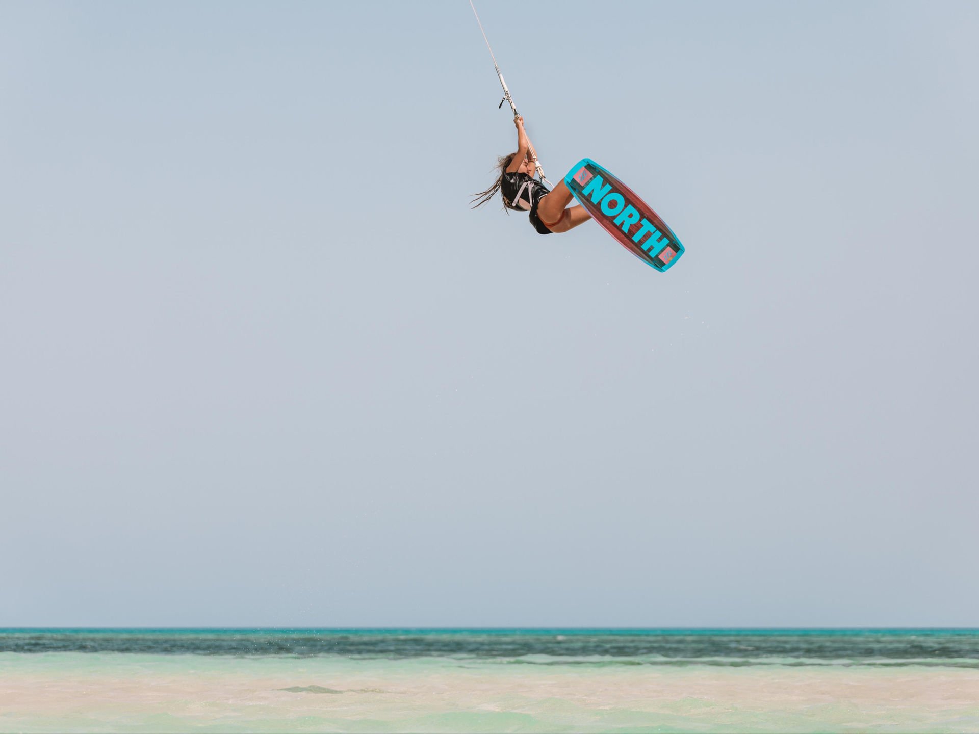 Aerial view of kitesurfers in turquoise Red Sea lagoon