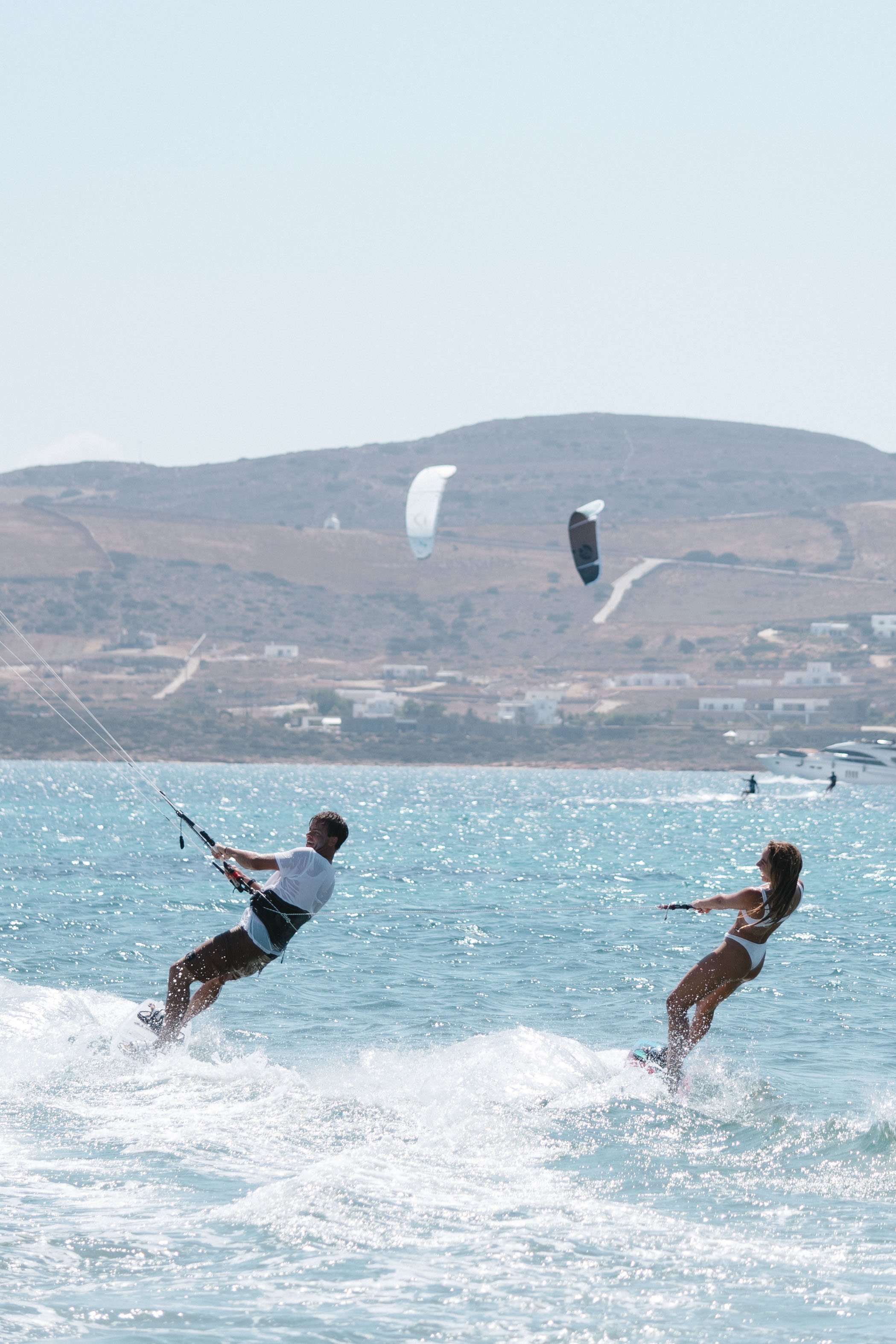 Two kitesurfers riding together in the Aegean