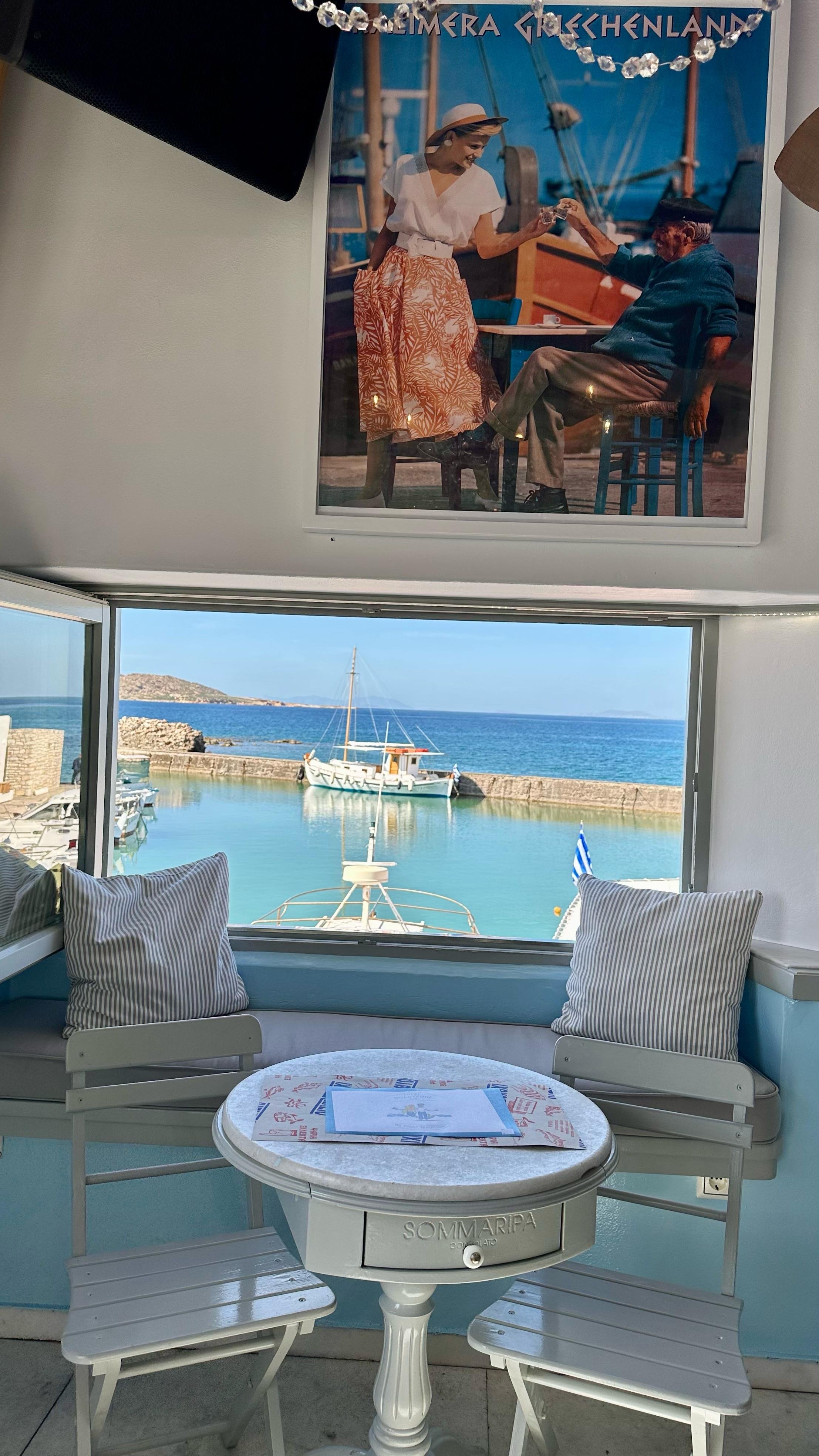 Cosy harbourside café with a view of the Greek port