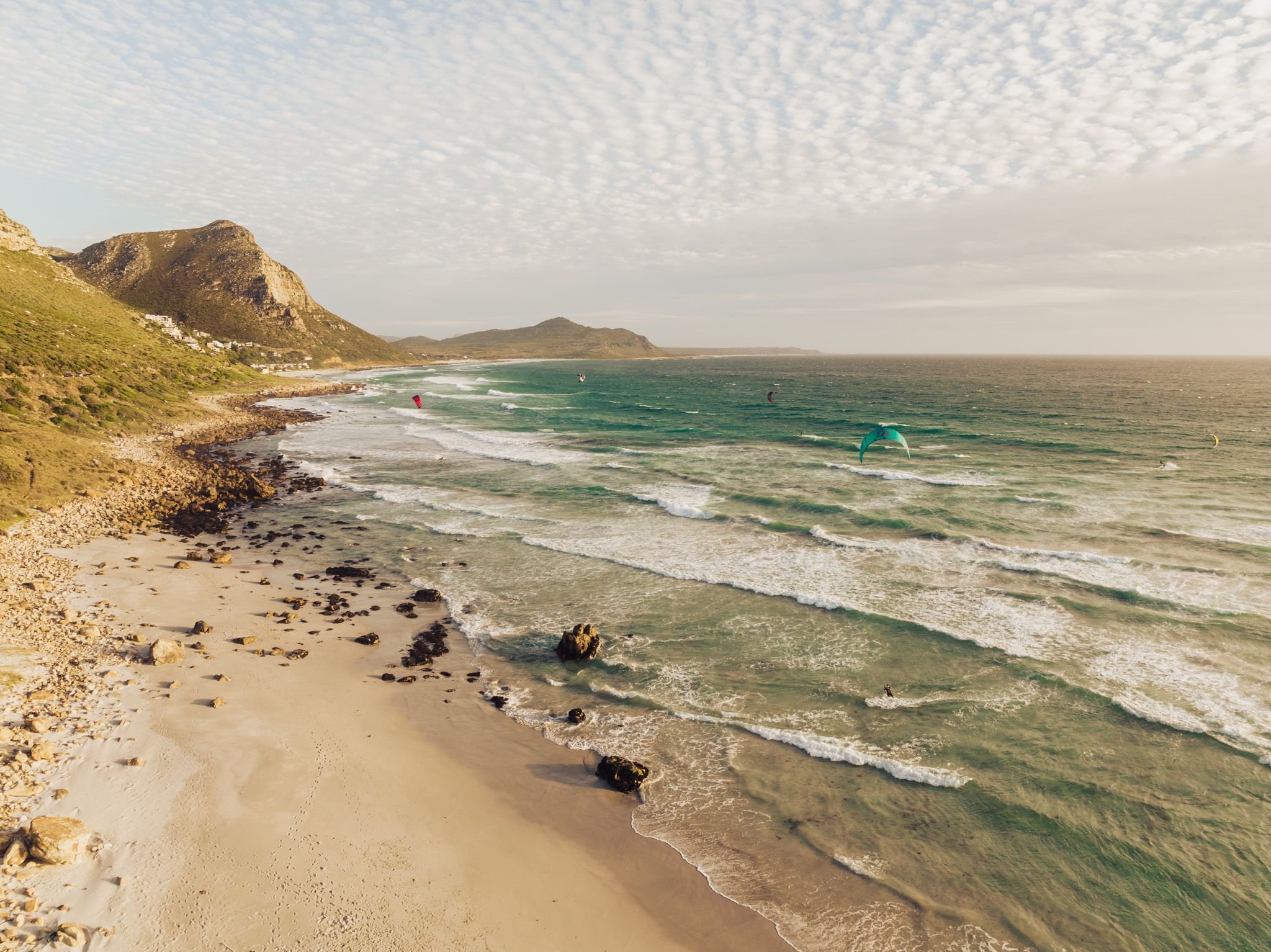 Cape Town aerial beach with kitesurfers and rocky coast
