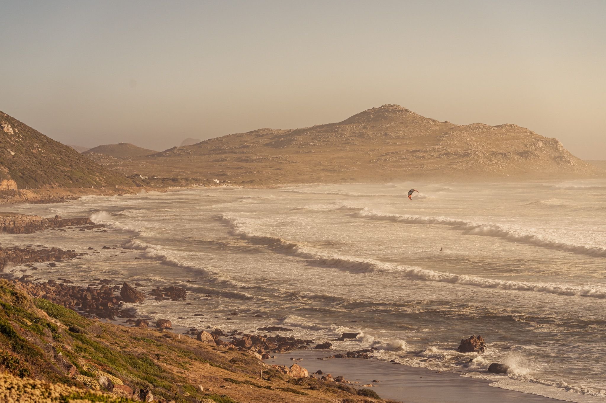Cape Town beach waves with a distant kitesurfer