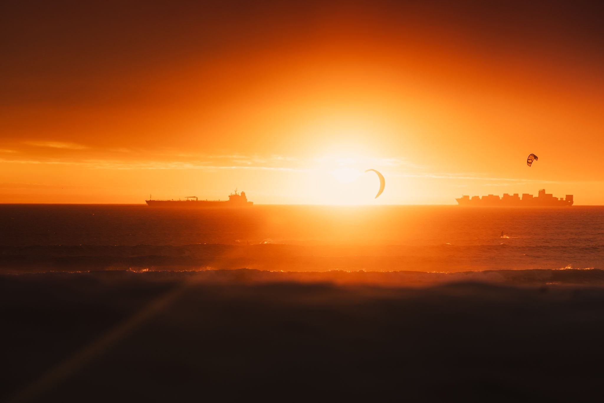 Cape Town sunset with a kitesurfer and passing ship