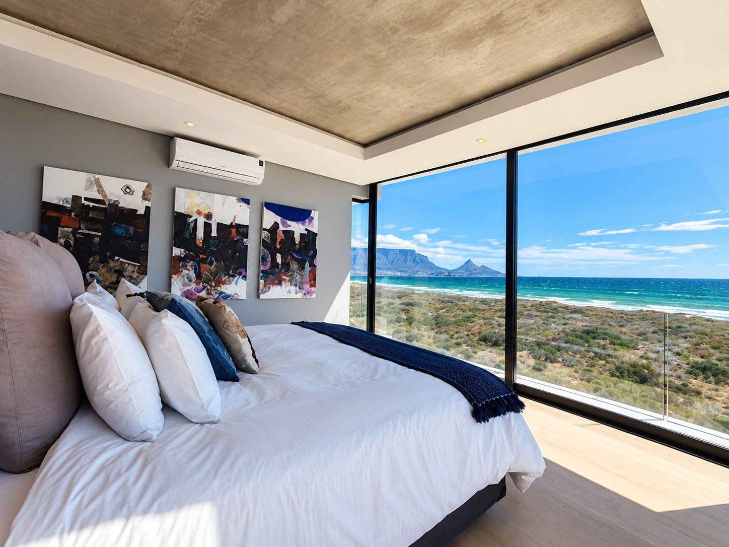 Sunset Beach Villa bedroom with artwork and large windows