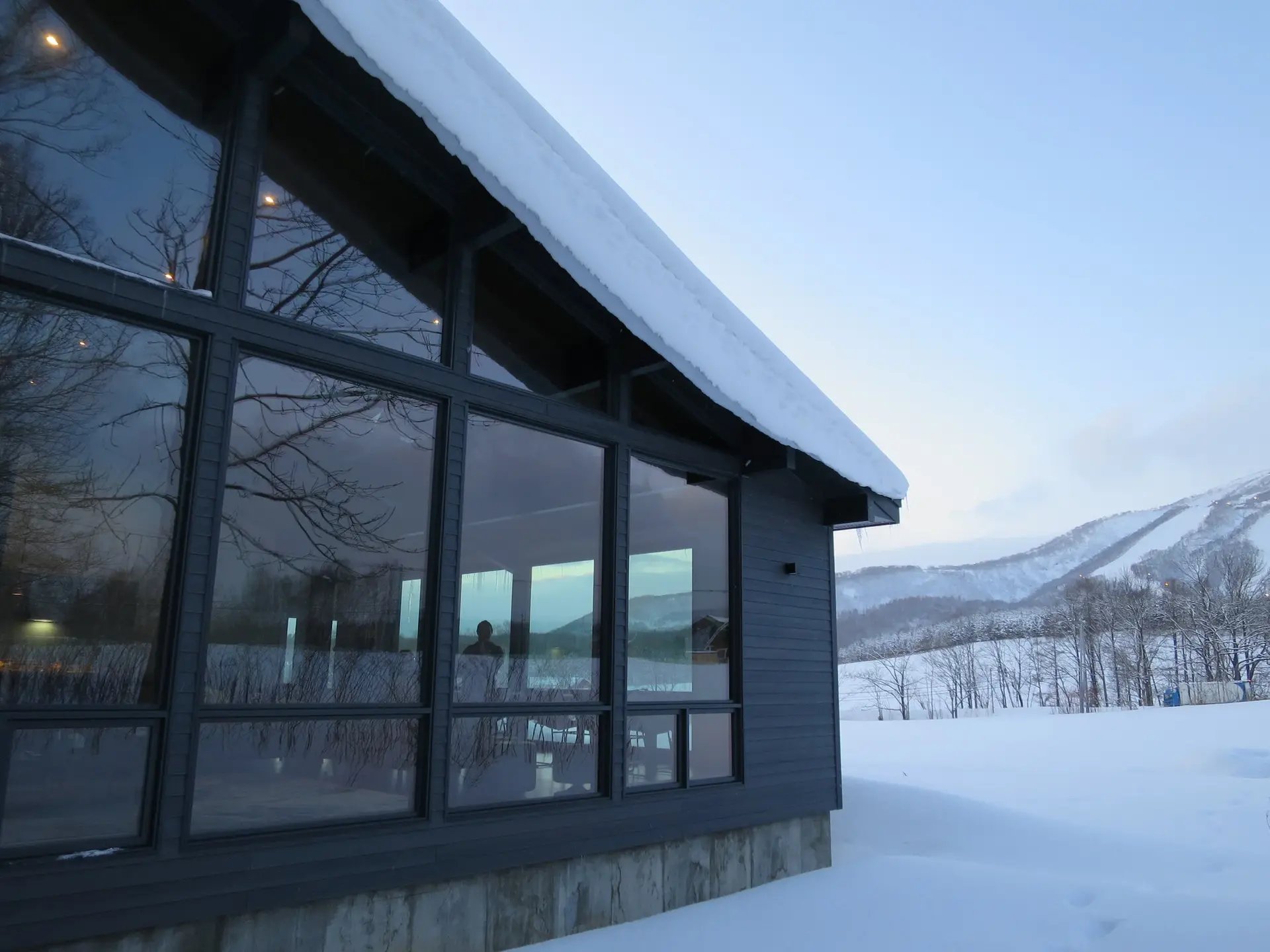 Niseko chalet glass facade at dusk