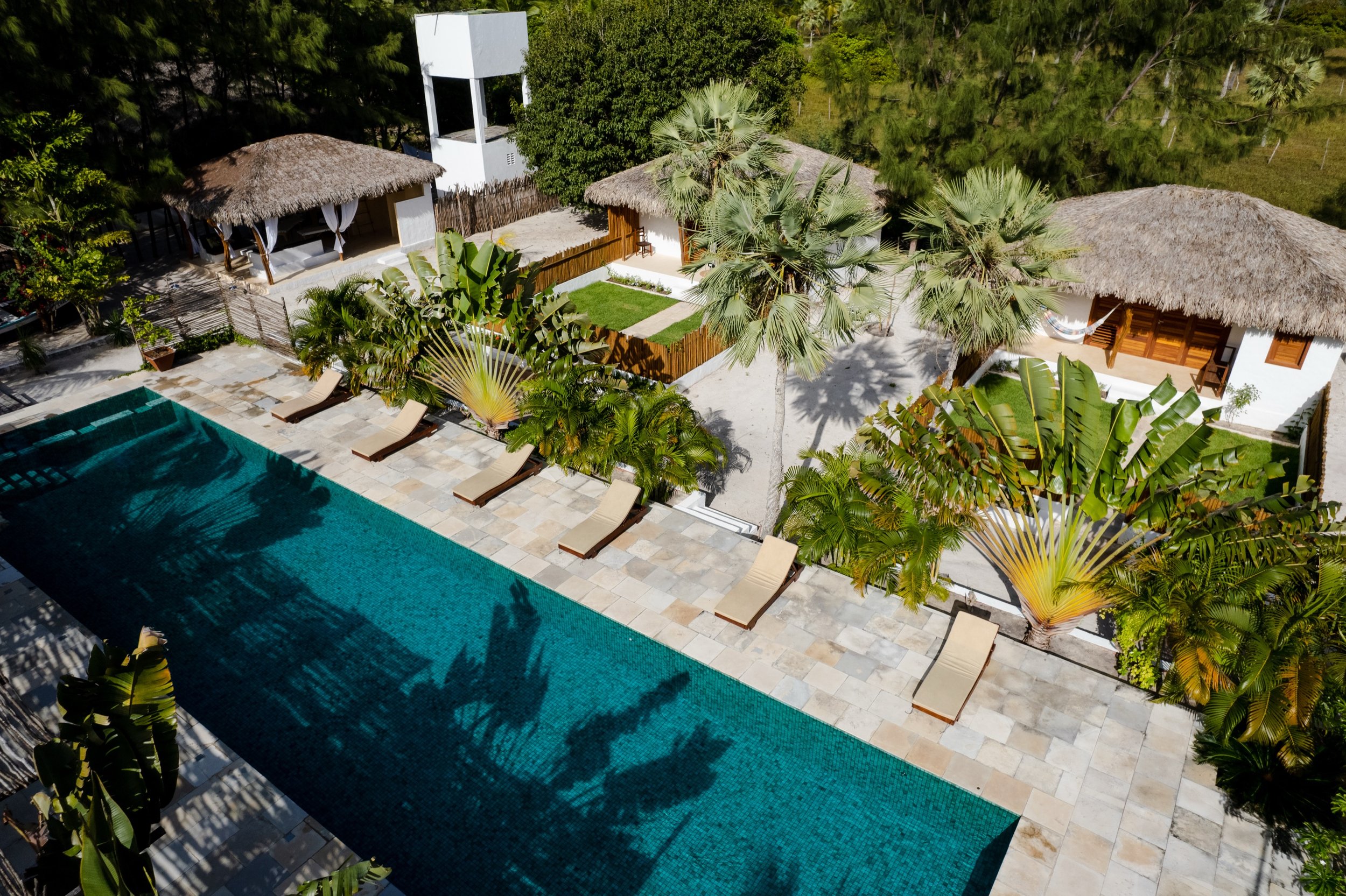Prea villa pool aerial with thatched bungalows