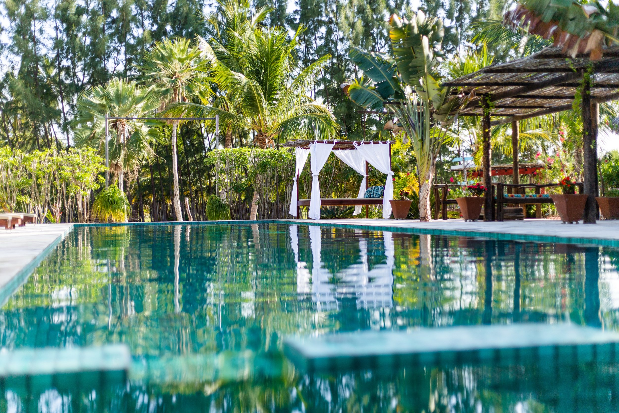Prea villa pool reflection with palm gazebo