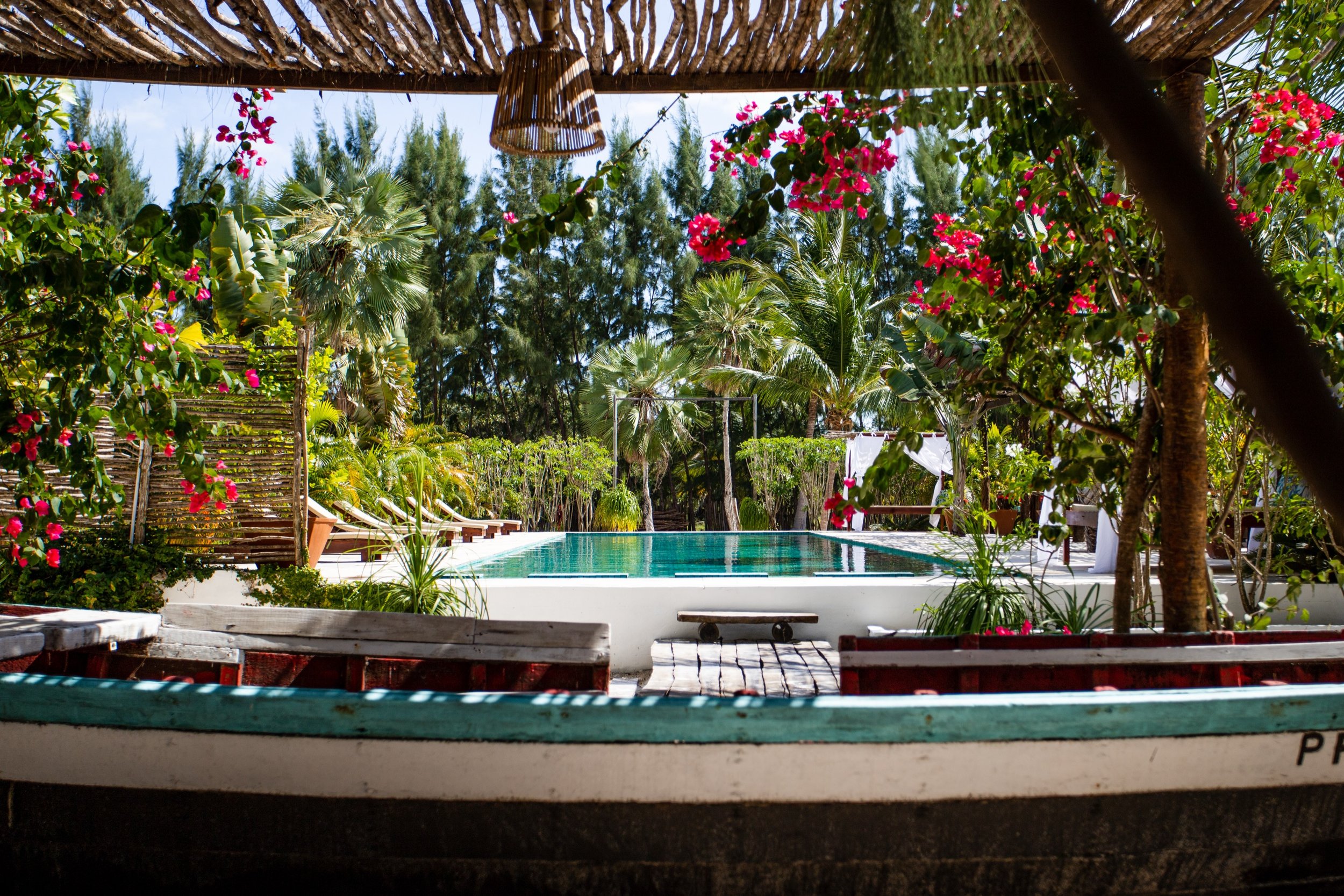 Prea villa pool through bougainvillea garden