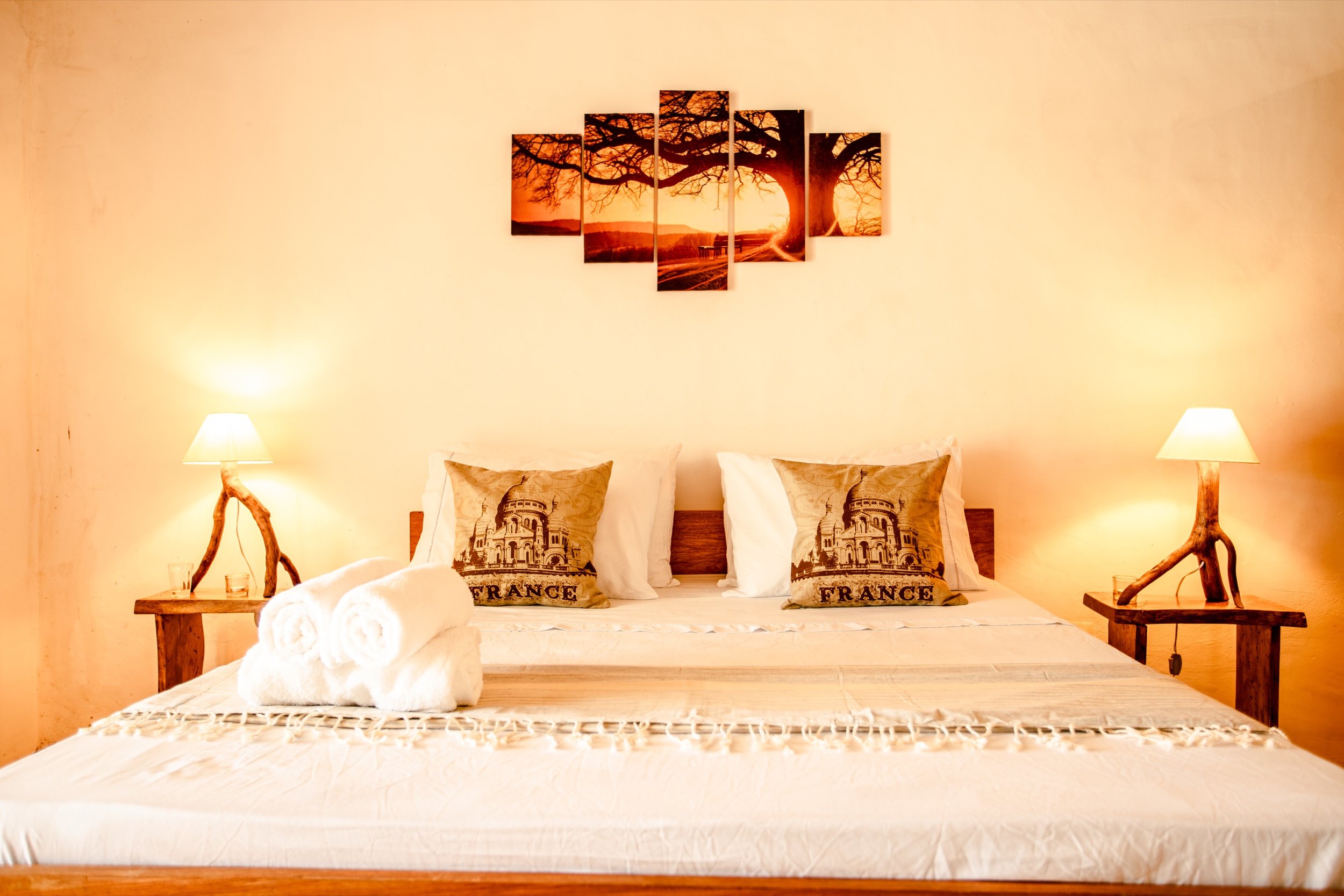 Prea villa bedroom with sunset wall art
