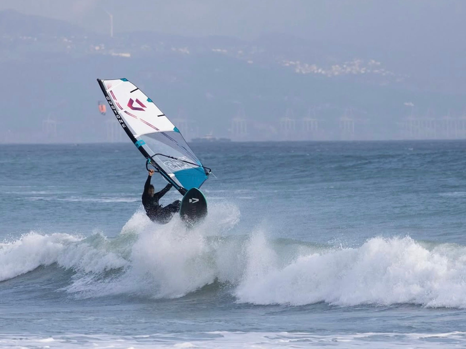 Tarifa surfers in the ocean at sunset