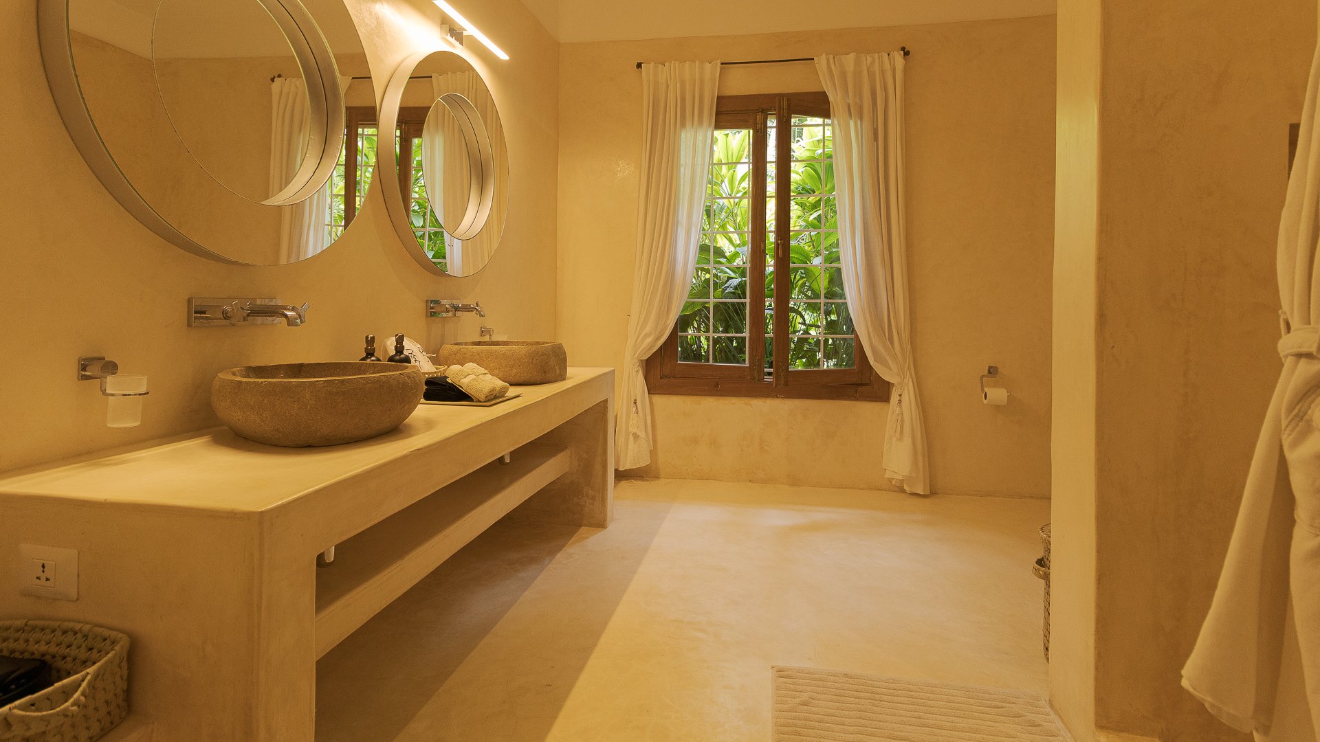 Watamu villa bathroom with stone sinks and garden window