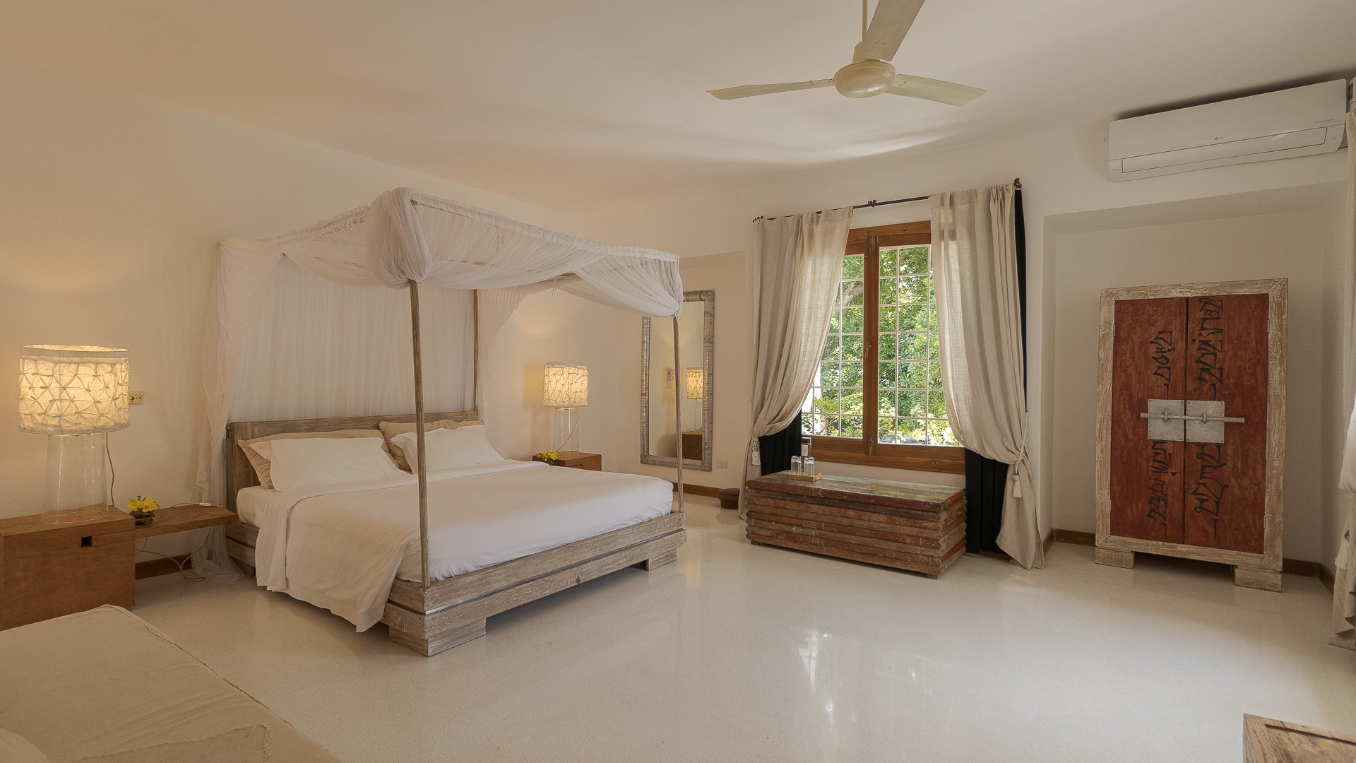 Watamu villa bedroom with four-poster canopy bed and ensuite